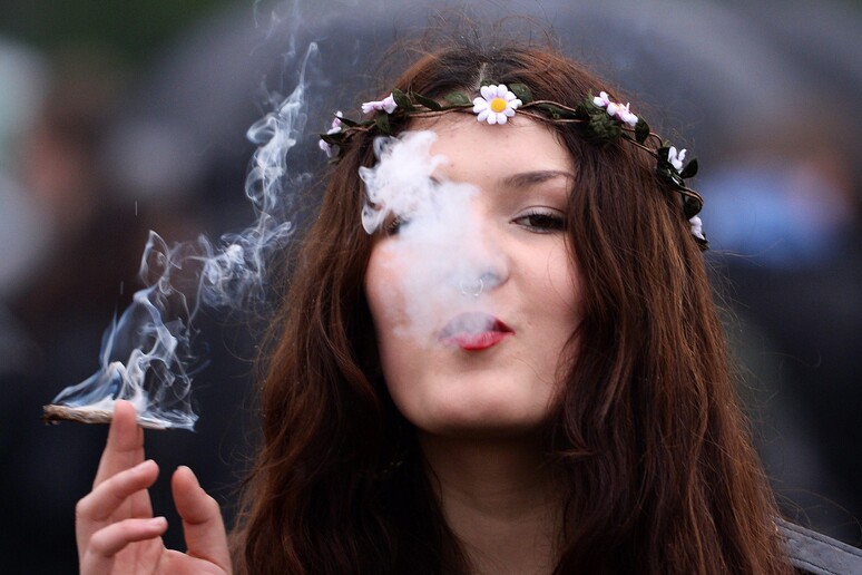 Foto d 'archivio di una donna che fuma uno spinello durante una manifestazione per la legalizzazione della cannabis © ANSA/EPA