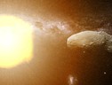 Rappresentazione artistica dell’asteroide Itokawa colpito dal vento solare (fonte: Curtin University) (ANSA)